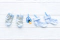 Baby socks on rope at wooden background Royalty Free Stock Photo