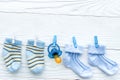 Baby socks on rope at wooden background Royalty Free Stock Photo