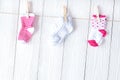 Baby socks on rope at wooden background Royalty Free Stock Photo