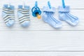 Baby socks on rope at wooden background Royalty Free Stock Photo