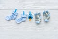 Baby socks on rope at wooden background Royalty Free Stock Photo