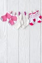 Baby socks on rope at wooden background Royalty Free Stock Photo