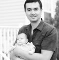 Baby son resting on Father's arm