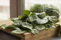 Baby spinach leaf on the kitchen wooden board Royalty Free Stock Photo