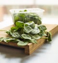 Baby spinach leaf on the kitchen wooden board Royalty Free Stock Photo