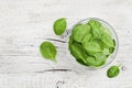 Baby spinach leaves in bowl on white rustic table, organic and healthy food Royalty Free Stock Photo