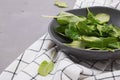 Baby spinach leaves in a rustic bowl on the gray stone background Royalty Free Stock Photo