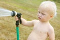 Baby Spraying Garden Hose Royalty Free Stock Photo