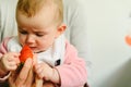 Baby starting by tasting a strawberry using the Baby led weaning BLW method Royalty Free Stock Photo