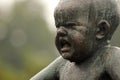 Baby statue Sinnataggen by Vigeland in Frogner park, Oslo, in rain tears