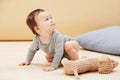 Baby, stuffed animal and playing in home for youth care, childhood development or game entertainment. Kid, toy teddy and