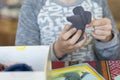 Baby stuffing a soft toy with cotton. ig. Crochet toy for child. On table threads, needles, hook, cotton yarn. Handmade crafts.