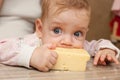 Baby sucked his lips to a large piece of cheese Royalty Free Stock Photo