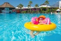 Baby in summer swimming pool resort