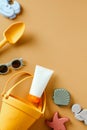 Baby Sunscreen with beach toys on sand color background. Sun cream design. Flat lay. Top view Royalty Free Stock Photo