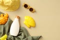 Baby sunscreen lotion bottle, kids sunglasses, sand molds, panama hat, towel on beige background Royalty Free Stock Photo