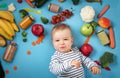 Baby surrounded with fruits and vegetables Royalty Free Stock Photo