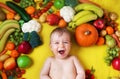 Baby surrounded with fruits and vegetables Royalty Free Stock Photo