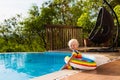 Baby in swimming pool. Kids swim. Child summer fun. Royalty Free Stock Photo