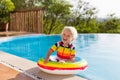Baby in swimming pool. Kids swim. Child summer fun. Royalty Free Stock Photo