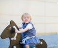Baby swing on horse on playground. Side view Royalty Free Stock Photo