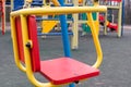 Baby swing with metal frames on deserted empty playground in city recreation park during coronavirus quarantine period