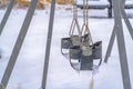 Baby swings on a playground viewed in winter Royalty Free Stock Photo