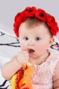 Baby takes thumb in her mouth Royalty Free Stock Photo