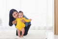 Baby taking first steps learning to walk with mother