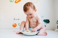 Baby taking handfuls of food to put in his mouth and eat them Royalty Free Stock Photo