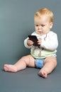 Baby texting smart phone Royalty Free Stock Photo