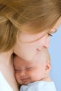 Baby of three months old in his mothers hands.