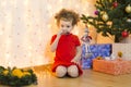 Baby toddler eats holiday treats, sweets, chocolate, tangerines