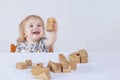 Baby toddler playing wooden toys at home or nursery on light background concept happy child, fun games Royalty Free Stock Photo