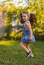 Baby toddler running on green lawn near the house. Royalty Free Stock Photo