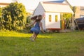 Baby toddler running on green lawn near the house. Royalty Free Stock Photo