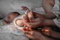 Baby toes of newborn and heels foot close-up in parents& x27; hands