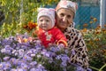 Baby together and grandmother in the flower garden Royalty Free Stock Photo