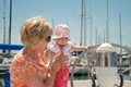 Baby touches wheel on a sailboat Royalty Free Stock Photo