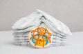 Baby toy on the background of a stack of baby diapers, close-up. Copy space for text Royalty Free Stock Photo