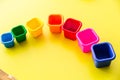 baby toy colored bucket on yellow table