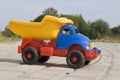 Baby toy dump truck on sunny road