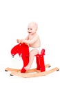 Baby on the toy horse or elk Royalty Free Stock Photo