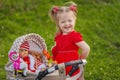 baby with toy stroller and doll Royalty Free Stock Photo