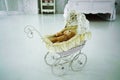 Baby toy stroller with teddy bear stands in the house Royalty Free Stock Photo