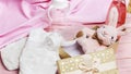 baby toys background with plush bunny, baby bottle, diaper on pink wooden background. top view, flat lay Royalty Free Stock Photo