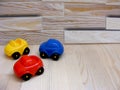 Baby toys blue red yellow cars on wooden background Royalty Free Stock Photo