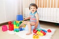 Baby with toys sitting on potty Royalty Free Stock Photo