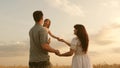 Baby travels across field with her family. child and parent are playing. happy family and childhood concept. Happy baby Royalty Free Stock Photo