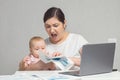 Baby tries to get attention from mother working on laptop Royalty Free Stock Photo
